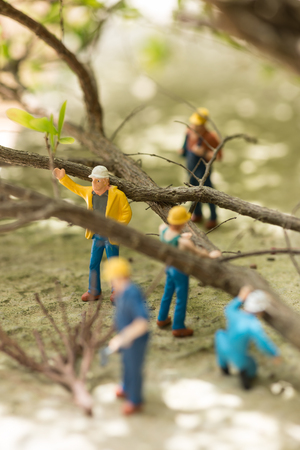 Miniature workmen clearing fallen trees close-upの写真素材