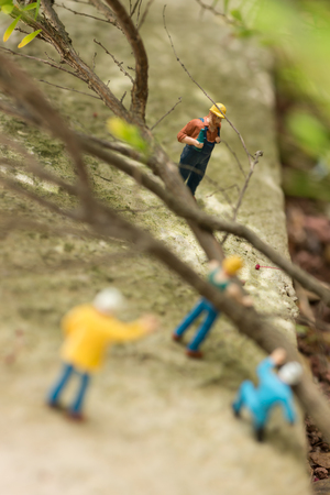 Miniature workmen clearing fallen treesの写真素材