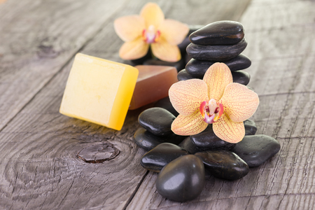 Yellow Moth orchids, soaps and black stones close-upの写真素材