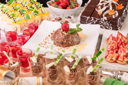 An array of Christmas desserts with bon bons on a tableの写真素材