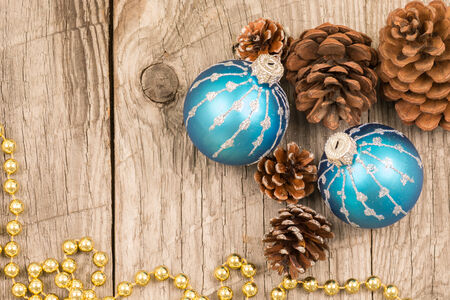 Christmas baubles, golden beads and pine conesの写真素材