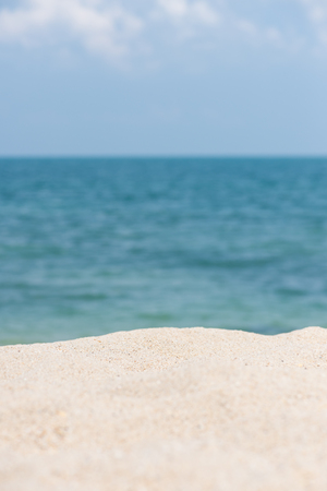 Sandy beach with horizon over calm blue seaの写真素材
