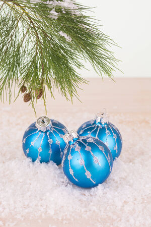Blue Christmas baubles in snowflakes and pine tree branchの写真素材