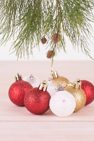 Red,  whte and gold Christmas baubles and pine tree branchの写真素材