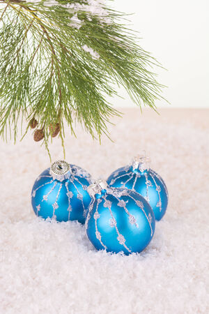 Blue Christmas baubles in snowflakes and pine tree branchの写真素材