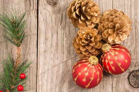 Christmas baubles and golden pine cones top viewの写真素材