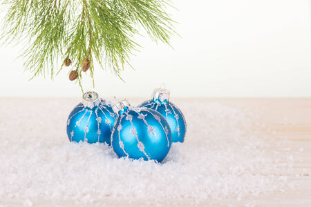 Blue Christmas baubles in snowflakes and pine tree branchの写真素材