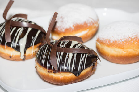 Chocolate and powdered sugar donuts close-upの写真素材