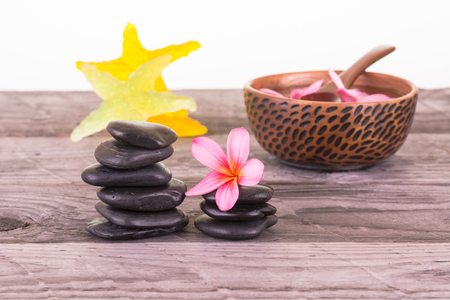 Plumeria flowers, starfish soaps and black stones close-upの写真素材