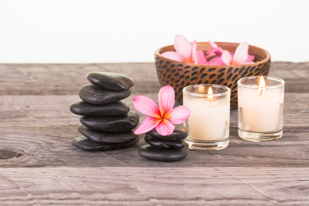 Frangipani flowers in a bowl and black stones close-upの写真素材