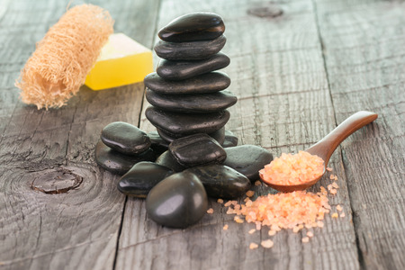 Spa with bath salt and stones on weathered wood backgroundの写真素材