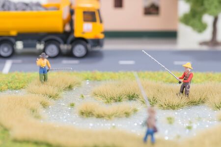 Miniature fishermen near road close upの写真素材