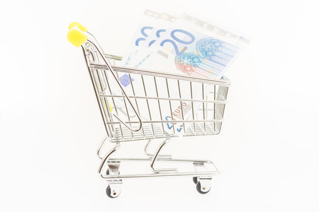 Miniature shopping cart with Euro banknotesの写真素材
