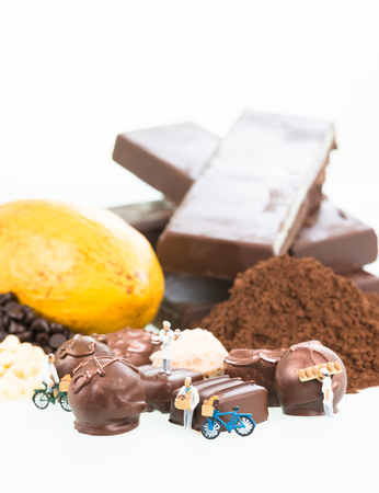Miniature pastry chefs and cocoa over white backgroundの写真素材
