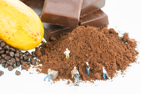 Miniature workers and cocoa over white backgroundの写真素材