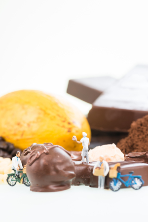 Miniature pastry chefs and cocoa over white backgroundの写真素材