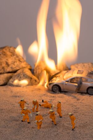 Miniature firemen at a car accident scene in flamesの写真素材