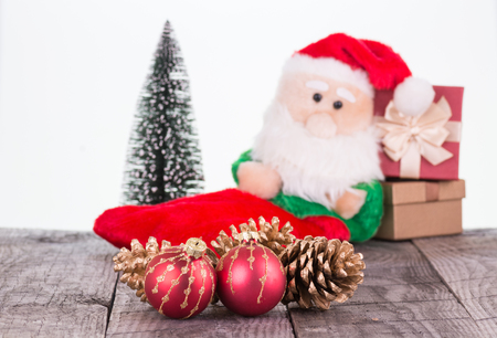 Santa Claus toy, christmas gift boxes and pine conesの写真素材