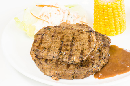 Grilled rib eye steak, corn on the cob and saladの写真素材