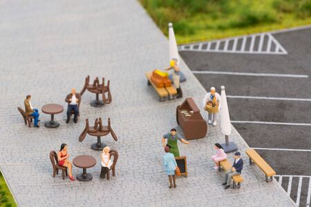 Miniature people at a sidewalk cafeの写真素材