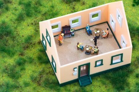 Miniature people having their meals in a restaurantの写真素材