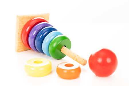 Wooden pyramid stacking rings toy on white background