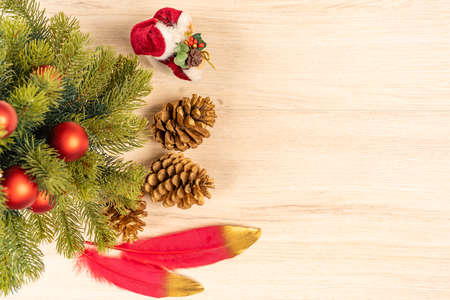 Christmas concept with tree, baubles, Santa, pine cones and feathers top viewの写真素材