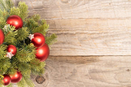 Christmas tree with red baubles on rustic wooden background top viewの写真素材