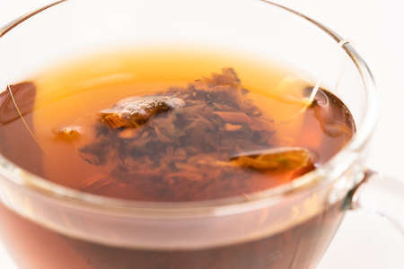 Aromatic hot herbal tea bag in a glass cup