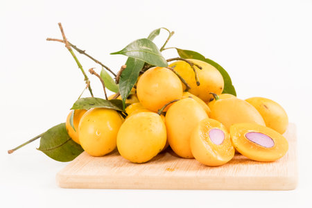 Fresh Marian Plum or Plum Mango fruits on wooden boardの写真素材