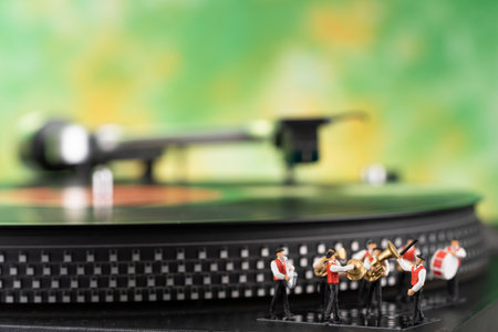Miniature brass band, turntable and yellow green backgroundの写真素材