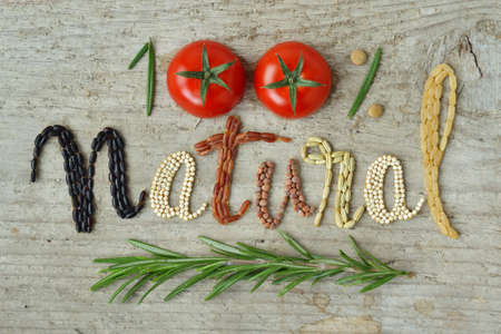 100% natural written with vegetables and cerealsの写真素材