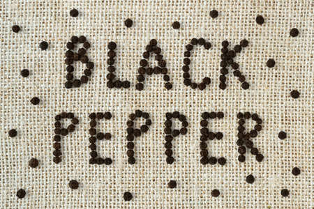 Black pepper writing on jute background