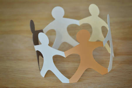 Paper people in a circle holding hands - Anti-racism and love concept