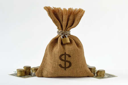 Money bag with padlock and chain, dollar banknotes and coins - Saving money and financial security...