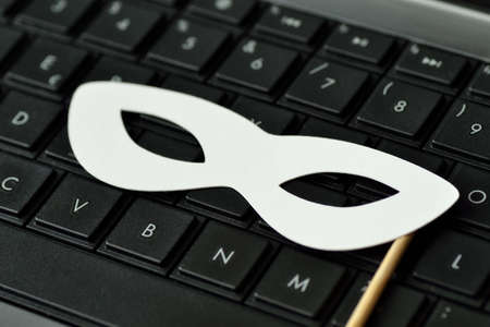 Mask on laptop keyboard - Privacy concept