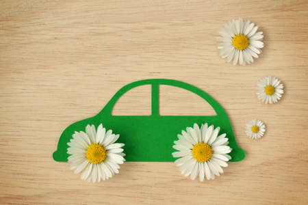 Paper car cut-out with daisy flowers - Eco-friendly car conceptの写真素材
