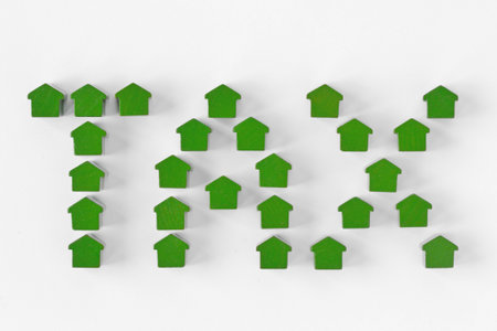 The word Tax written with miniature houses - Property tax conceptの写真素材