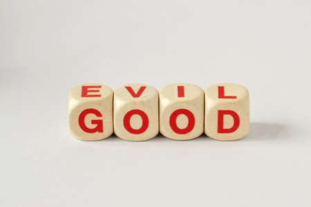 Good and Evil written with wooden cubesの写真素材