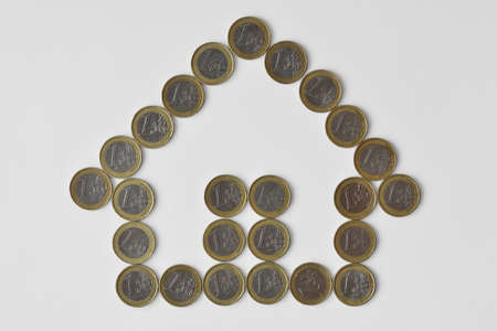 ouse made of euro coins on white background - Concept of real estate business