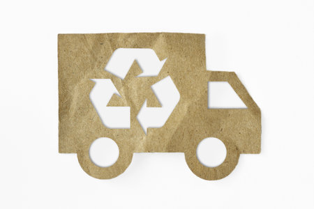 Recycled paper cut of truck with recycling symbol on white background - Green transportation conceptの写真素材