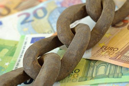 Rusty chain on euro money - Banking and finance conceptの写真素材