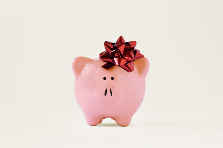 Piggy bank with red bow - Concept of giving away money bonusの写真素材