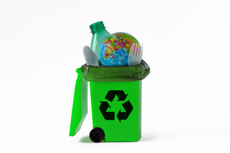 Planet Earth into recycle can with plastic trash - Concept of recycling and ecologyの写真素材