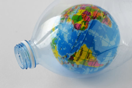 Earth globe in plastic bottle - Concept of plastic pollution and ecologyの写真素材
