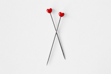 Two heart shaped pins on white background - Concept of love and relationshipの写真素材