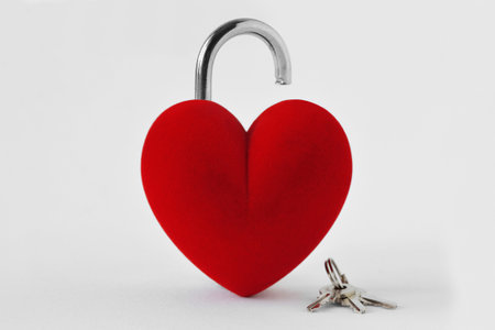 Open heart shaped padlock with keys on white background - Concept of loveの写真素材