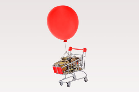 Shopping cart full of coins and red balloon floating on white background