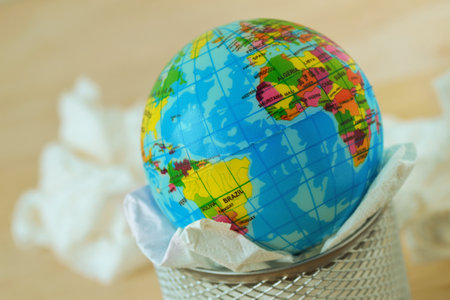 Close-up of planet earth in trash basket
