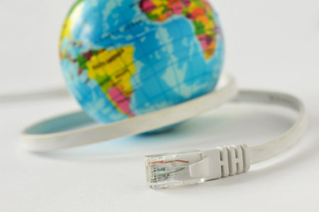 Internet cable with earth planet on white background - Concept of global internet connectionの写真素材
